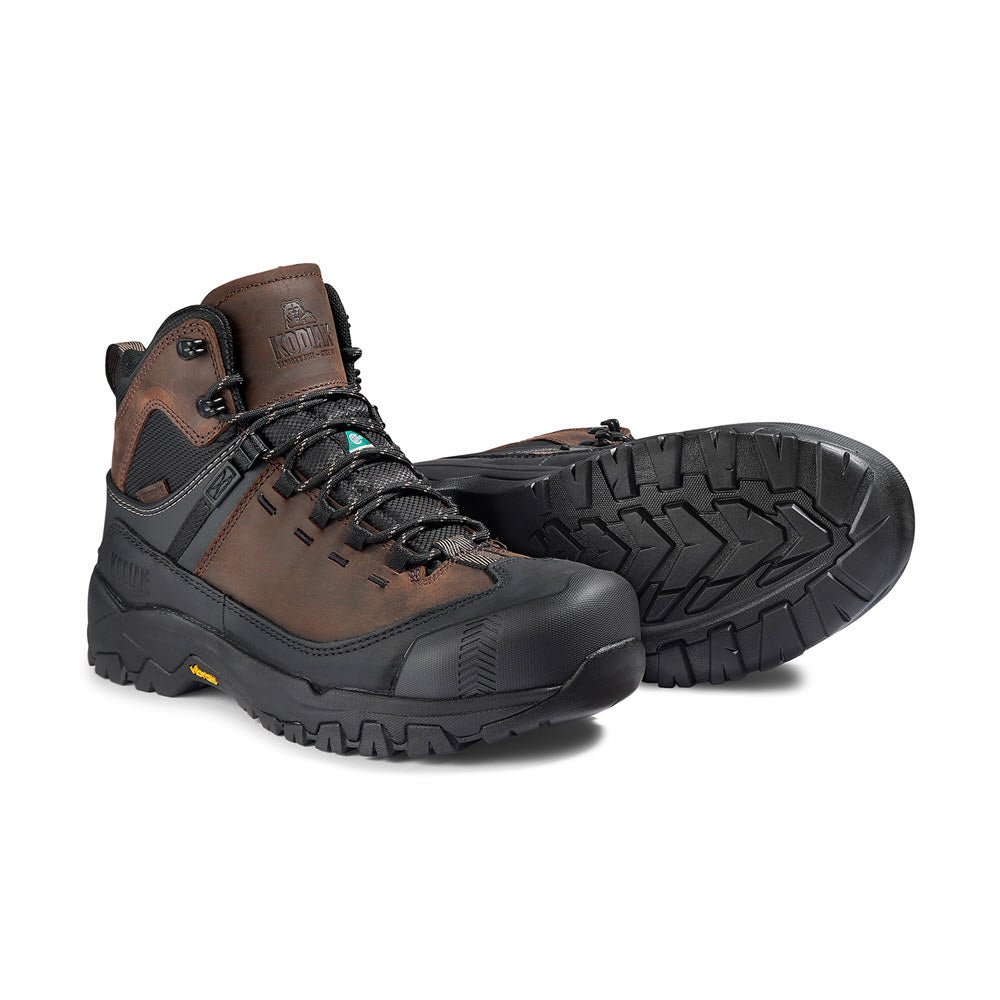 A pair of Kodiak Quest Bound Mid Composite Toe Waterproof Boots in dark brown, featuring reinforced ankle support and a Vibram® TC4+ rubber outsole for enhanced slip resistance.
