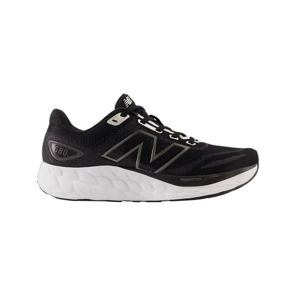 Black and white NEW BALANCE 680V8 running shoe with a prominent "n" logo and cushioned midsole, isolated on a white background.