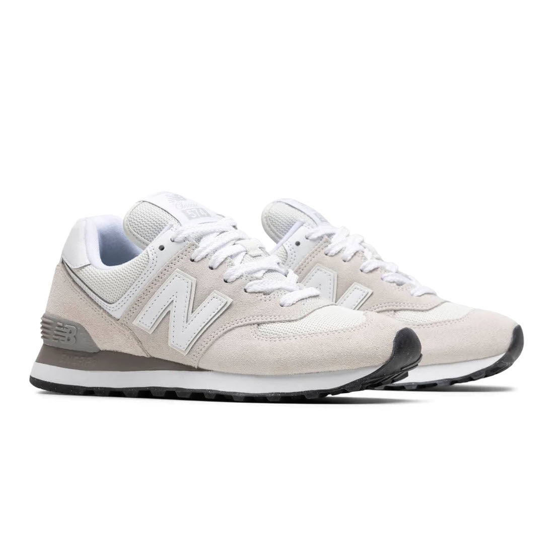 A pair of new New Balance 574 Nimbus Cloud sneakers in beige with white &quot;n&quot; logo, resting on a plain white background.