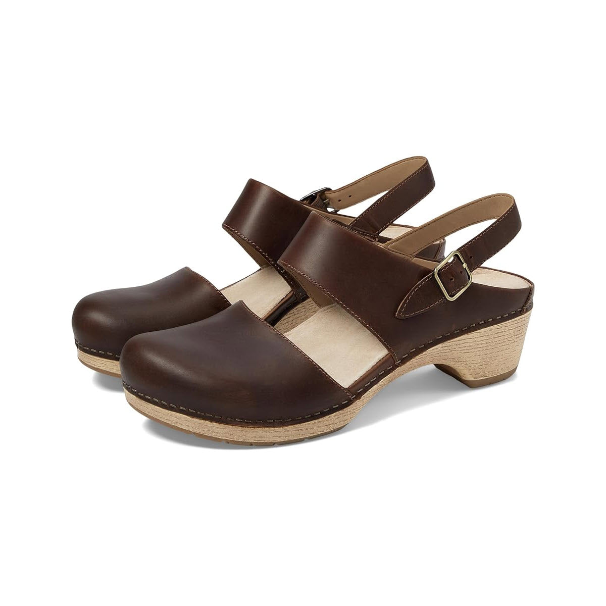 A pair of Dansko women&#39;s Lucia Tan leather sandals with an adjustable heel strap and wooden heels against a white background.