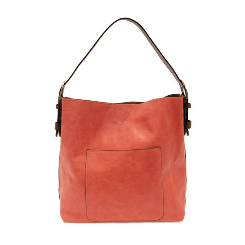 Joy Susan living coral hobo bag with a front pocket and a single shoulder strap, isolated on a white background.