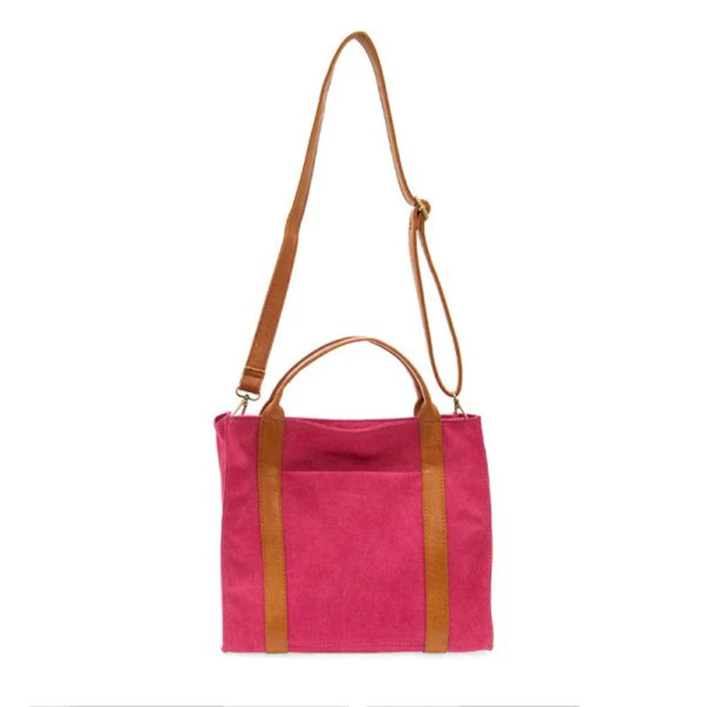 Magenta canvas tote with brown buffalo vegan leather straps and a long, adjustable shoulder strap against a white background.