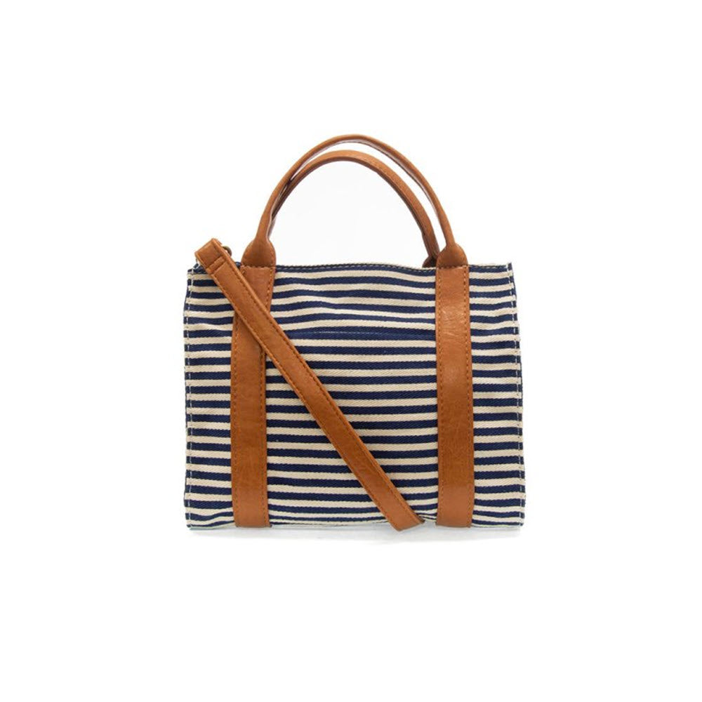 Joy Susan Gwen medium canvas tote in navy/white with brown leather handles and a shoulder strap, displayed against a white background.