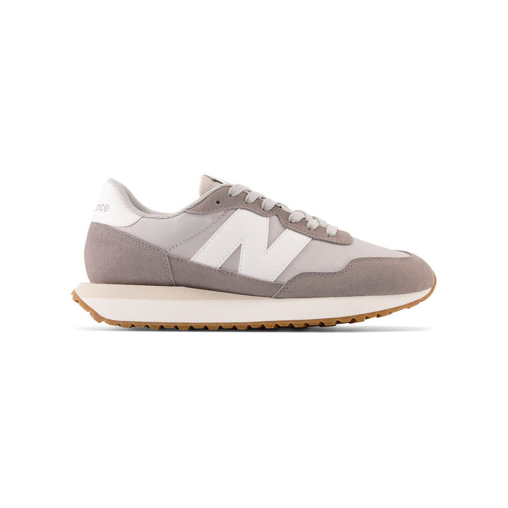 Gray New Balance WS237 Marblehead running shoes with a large white "n" logo on the side, featuring a beige sole and white laces, displayed against a white background.