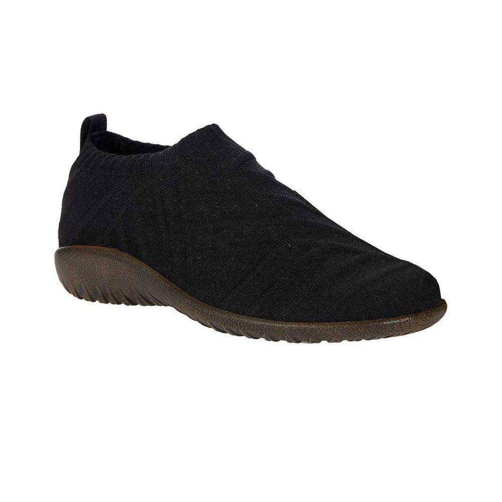 A single Naot Okahu Black Knit - Womens slip-on sneaker with a removable footbed, featuring a textured upper and a brown rubber sole, isolated on a white background.