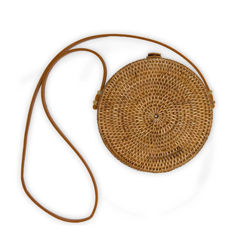 Round hand-woven Pokoloko Circle Rattan Bali Bag Caramel with a long leather strap, displayed on a white background.