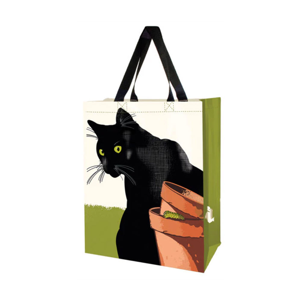 LINNEA VERTICAL MARKET TOTE CAT made from recycled materials, featuring a graphic of a black cat peeking out from behind a stack of books on a green background.