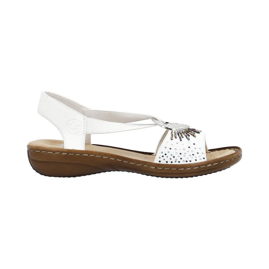 White Rieker slingback flats with rhinestone embellishments on the front, featuring a circular logo and a brown, shock-absorbing sole, isolated on a white background.