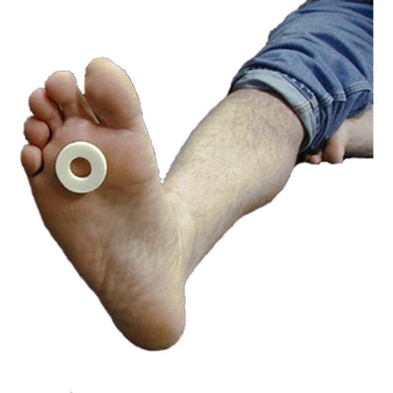 A person resting their bare foot on its side with a Dr. Jill&#39;s LW FOOT CARE ADHESIVE FELT RING PAD positioned on the sole for foot care and callus protection.