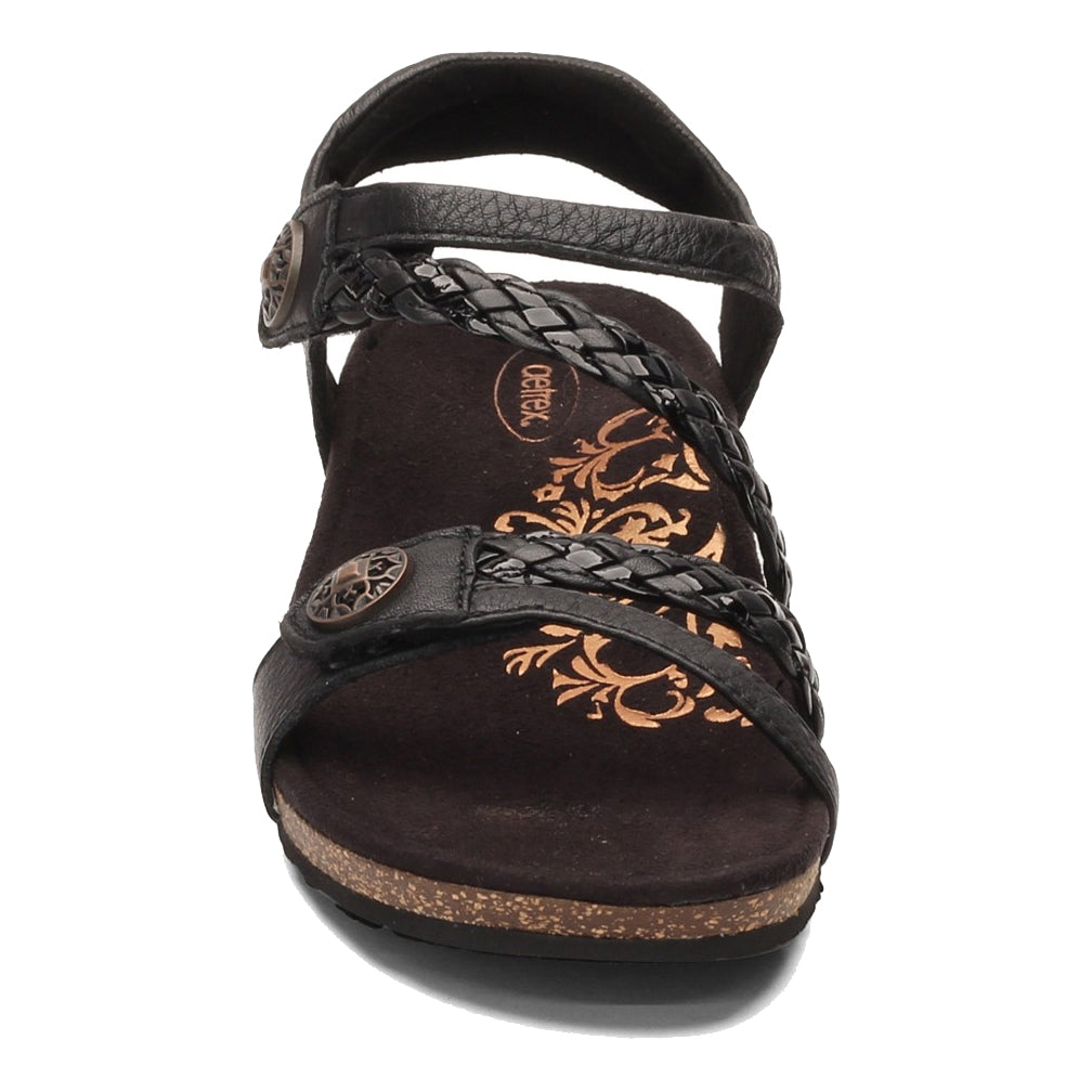 A black strappy Aetrex JILLIAN BLACK - WOMENS with decorative floral imprint on the insole and arch support.