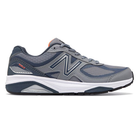 Side view of a gray New Balance 1540v3 Gunmetal/Dragonfly women's running shoe with blue and orange accents designed for overpronation.