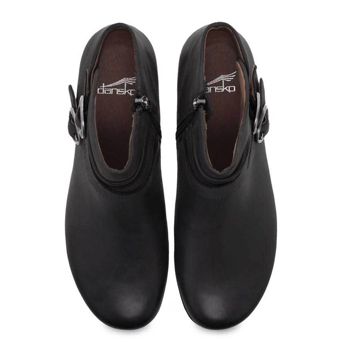 A pair of black Dansko Faithe Black Burnished Nubuck - Womens clogs viewed from above, featuring the Dansko Natural Arch technology and showing the upper part with the brand name inside.