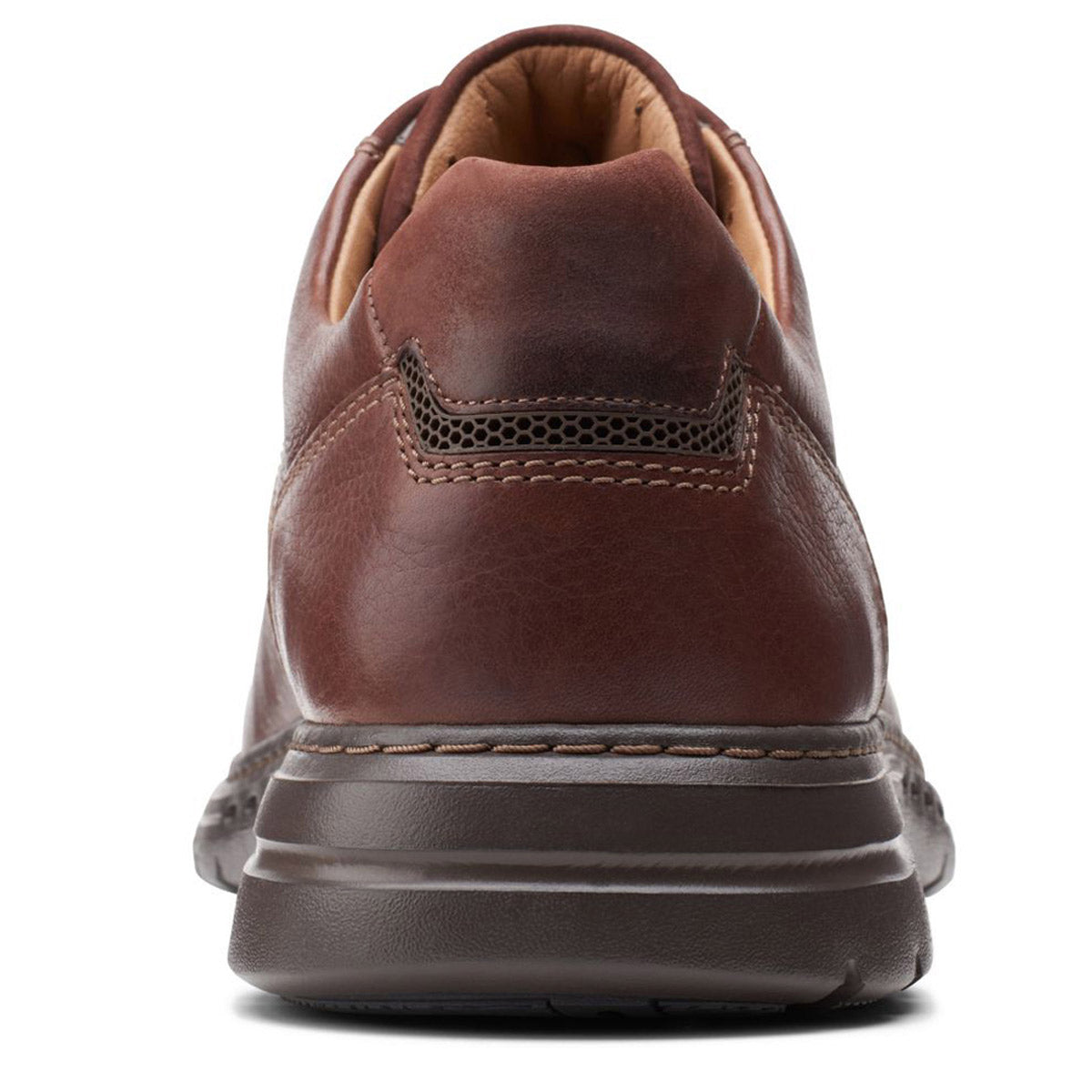 Close-up view of the back of a Clarks Un Brawley Pace Mahogany men&#39;s shoe with decorative stitching and rubber sole.