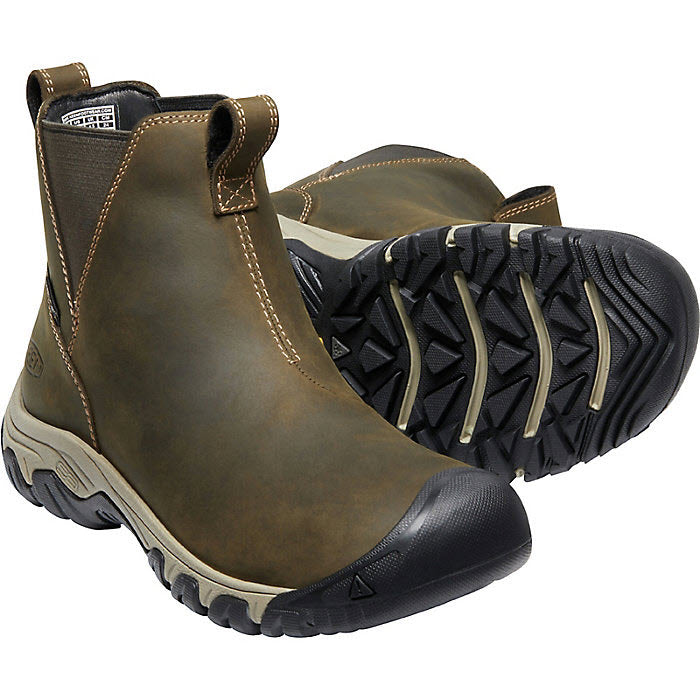 A pair of brown, slip-on, waterproof hiking boots with black Keen.Freeze rubber outsoles.