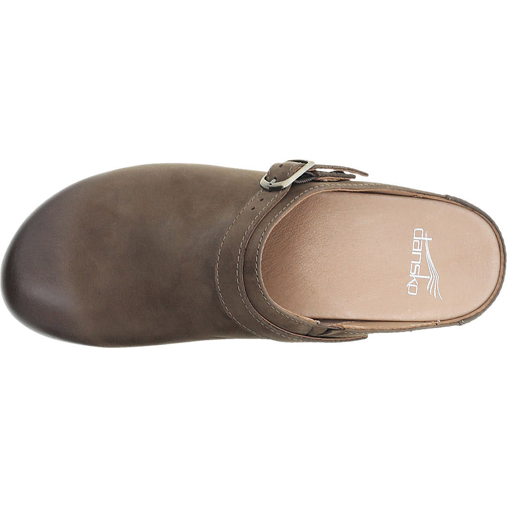 Top view of a single brown, closed-toe, Dansko Berry Mule with a strap over the instep, featuring Natural Arch™ technology.