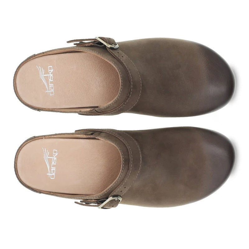A pair of Dansko Berry Brown Milled Burnished slip-on shoes with buckle detailing, viewed from above.