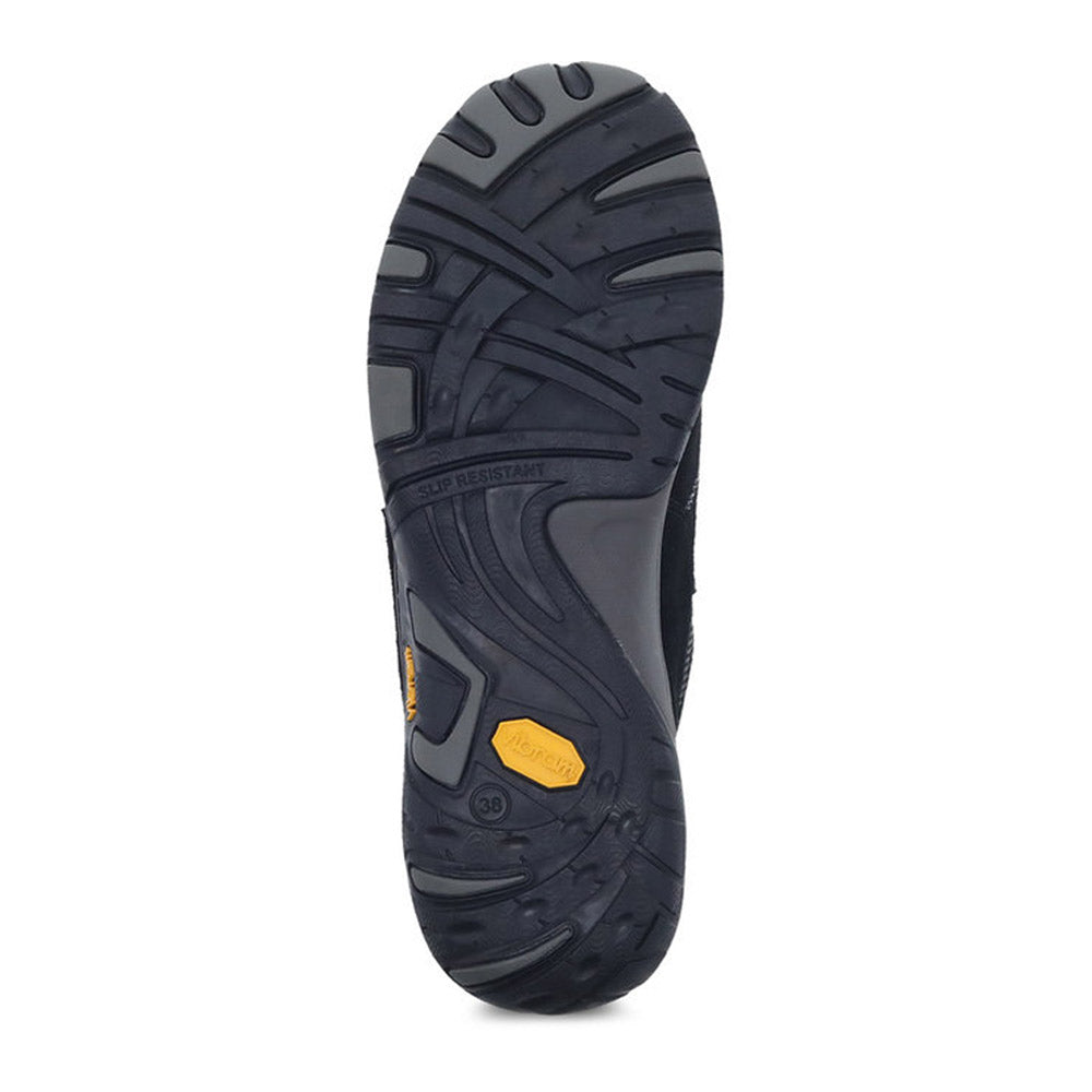 Sentence with the replaced product and brand name: Sole of a black Dansko Paisley Black/Black Suede - Women shoe displaying tread pattern and slip-resistant label.