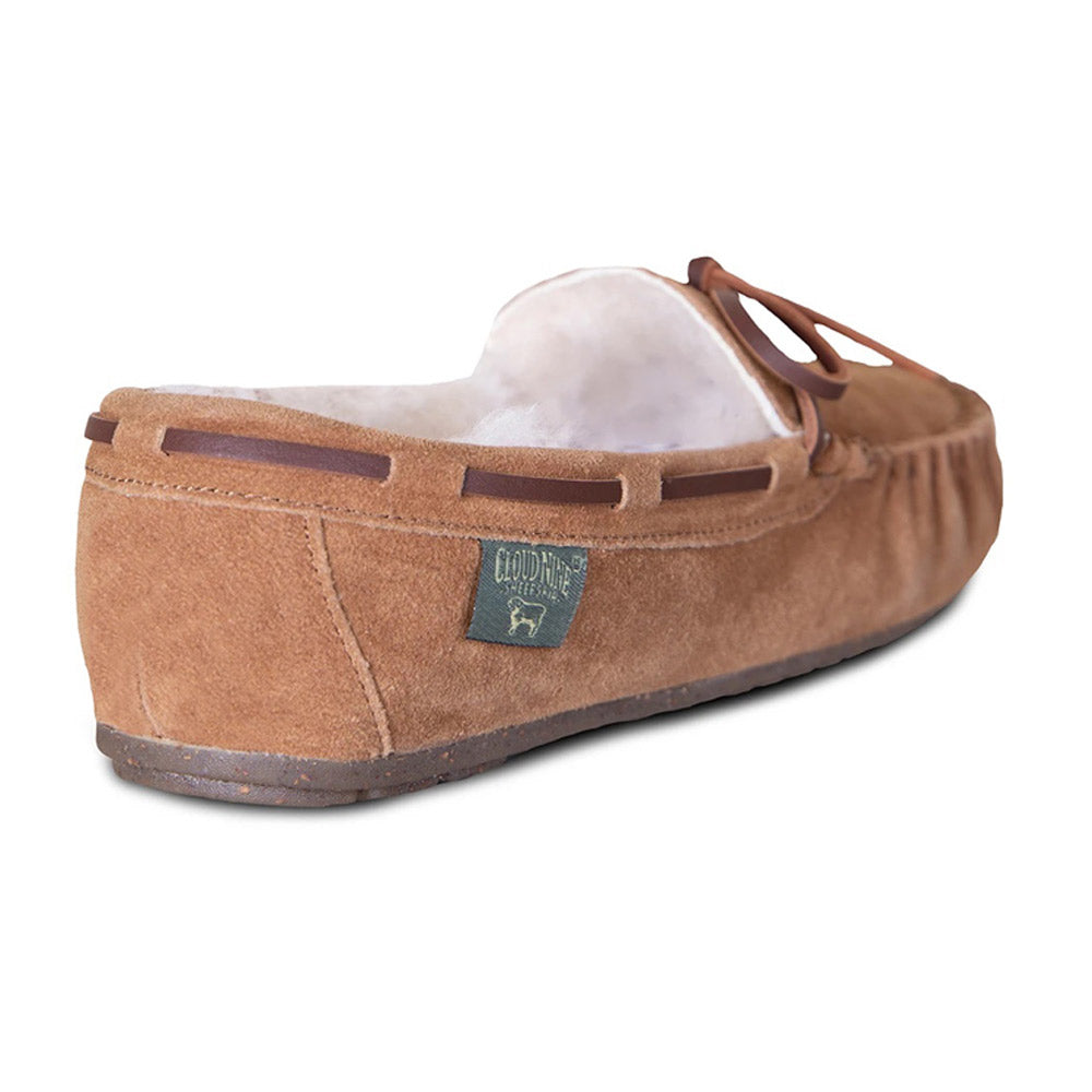 Brown suede Cloud Nine women’s moccasin slipper with sheepskin lining on white background.