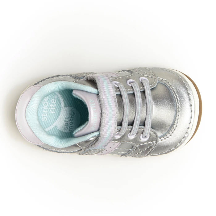 Child&#39;s Stride Rite SRT SM Artie Silver sneaker with pink details and untied laces on a white background.