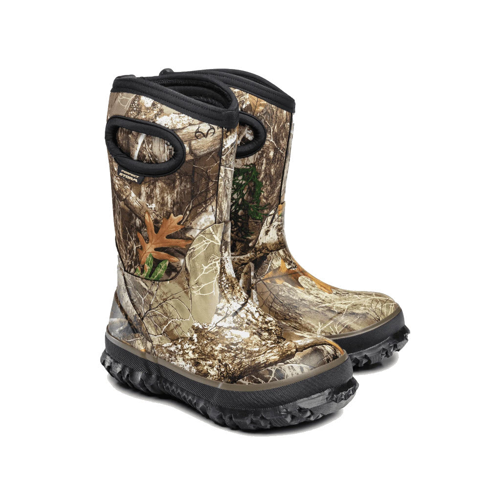 A pair of Perfect Storm Cloud Hi Camo - Kids hunting boots isolated on a white background.