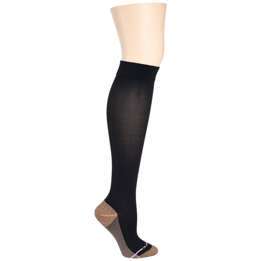 A mannequin leg wearing a black knee-high, anti-microbial Dr. Motion Compression sock with copper.