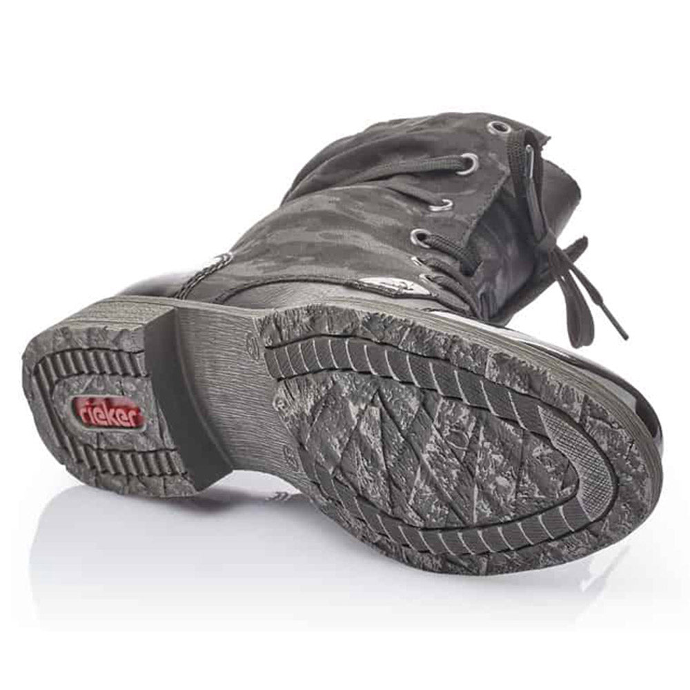 A single women’s Rieker Lace Up Bootie in Black Camo Print, lying on its side, showing the sole pattern and brand logo.