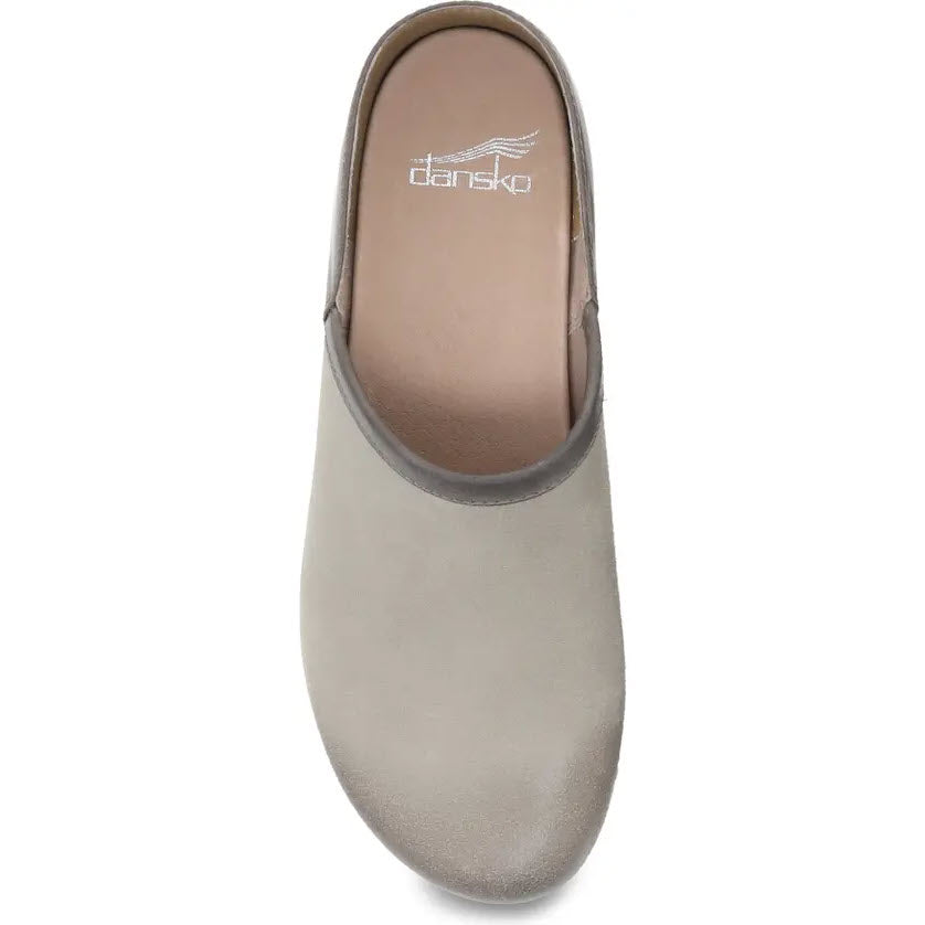 Top view of a single gray Dansko Brenna Taupe Burnished clog shoe with a rounded toe and a small logo imprint on the insole.