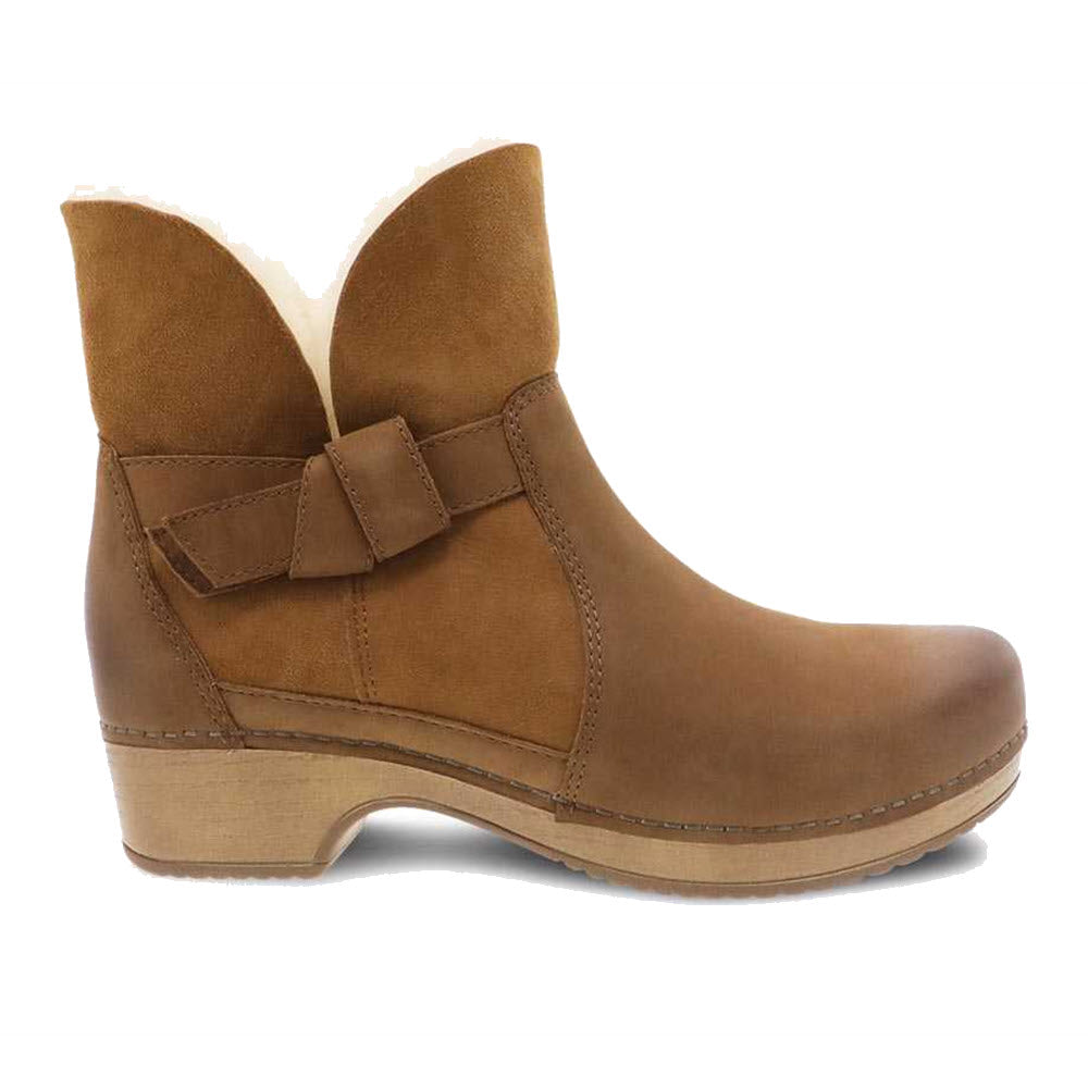Dansko Bessie Honey Burnished ankle boot with a decorative side buckle and fur trim.