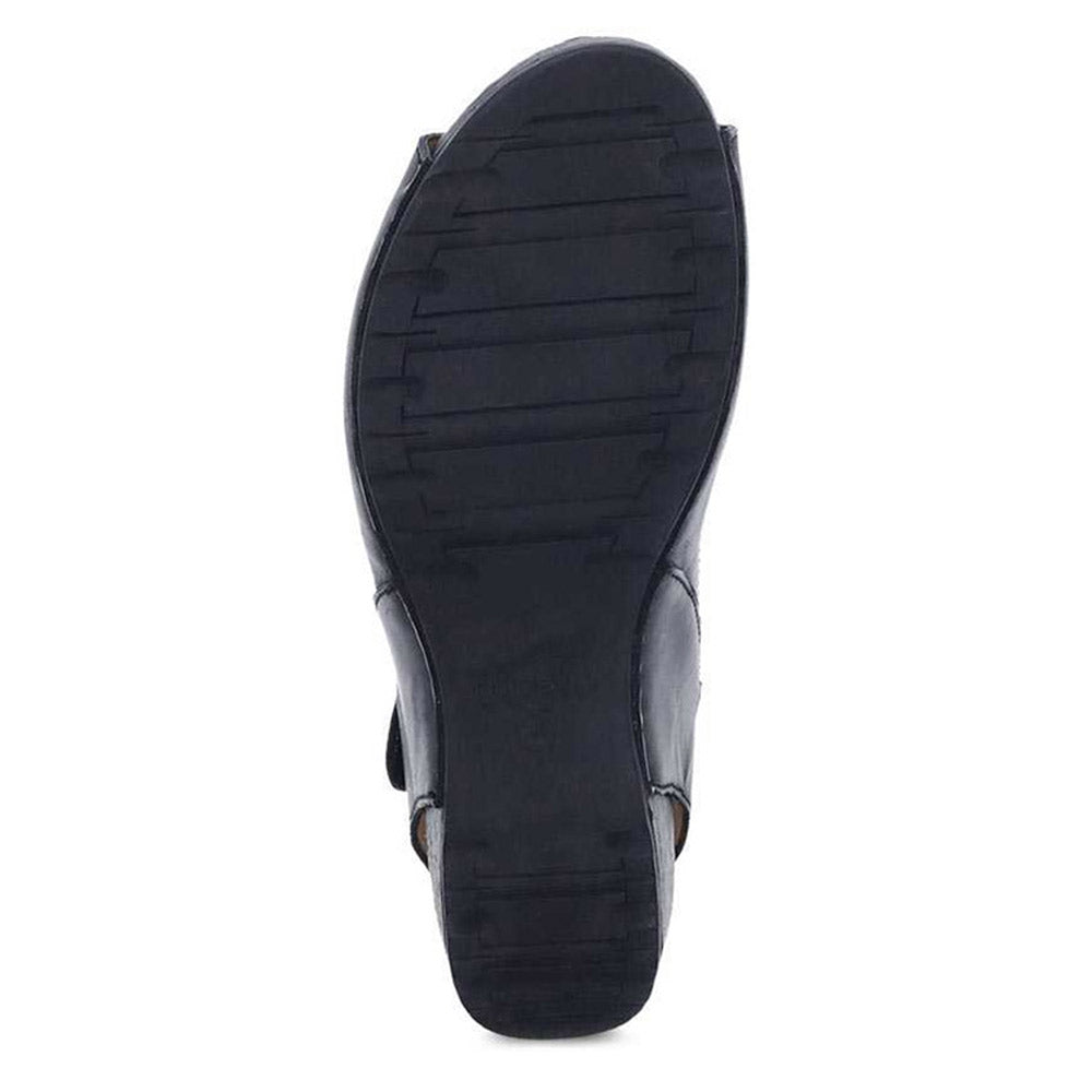 Replace the product in the sentence below with the given product name and brand name.
Sentence: Sole of a black Dansko Tiana sandal with horizontal tread pattern.
Product Name: DANSKO TIANA BLACK BURNISHED - WOMENS
Brand Name: Dansko