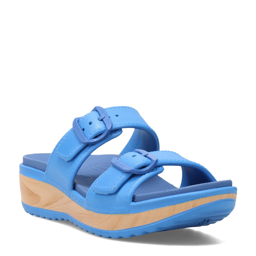 A blue Dansko Kandi summer sandal with adjustable straps and a layered sole design against a white background.