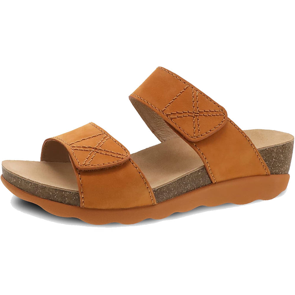 A pair of brown leather Dansko Maddy Slide sandals, designed specifically for women with a lightweight cork midsole.