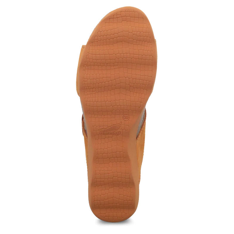 Sole of a Dansko Maddy Orange Milled Nubuck - Women&#39;s sandal with a textured pattern and brand emblem.