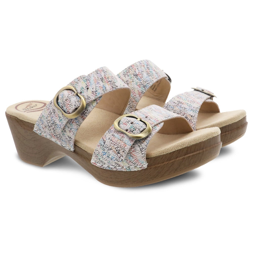 A pair of Dansko Sophie White Multi Slide Sandals for women with printed straps and buckle closures, featuring moisture-wicking Dri-Lex lining on a white background.