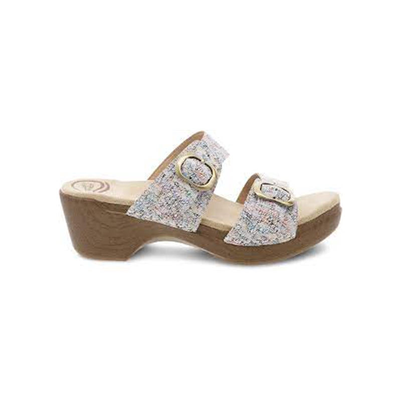 A pair of floral patterned, buckle-strap Dansko Sophie Slide Sandals with a raised heel.