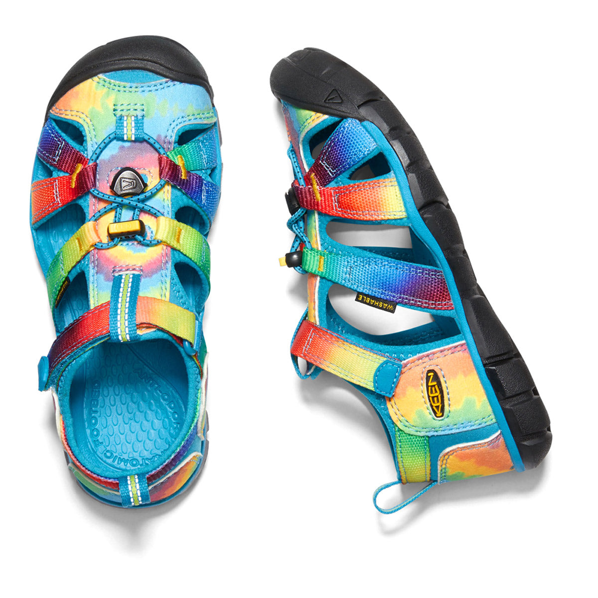 A pair of colorful Keen CHILD SEACAMP II CNX VIVID BLUE TIE DYE sandals with a closed-loop Secure Fit Lace Capture System on a white background.