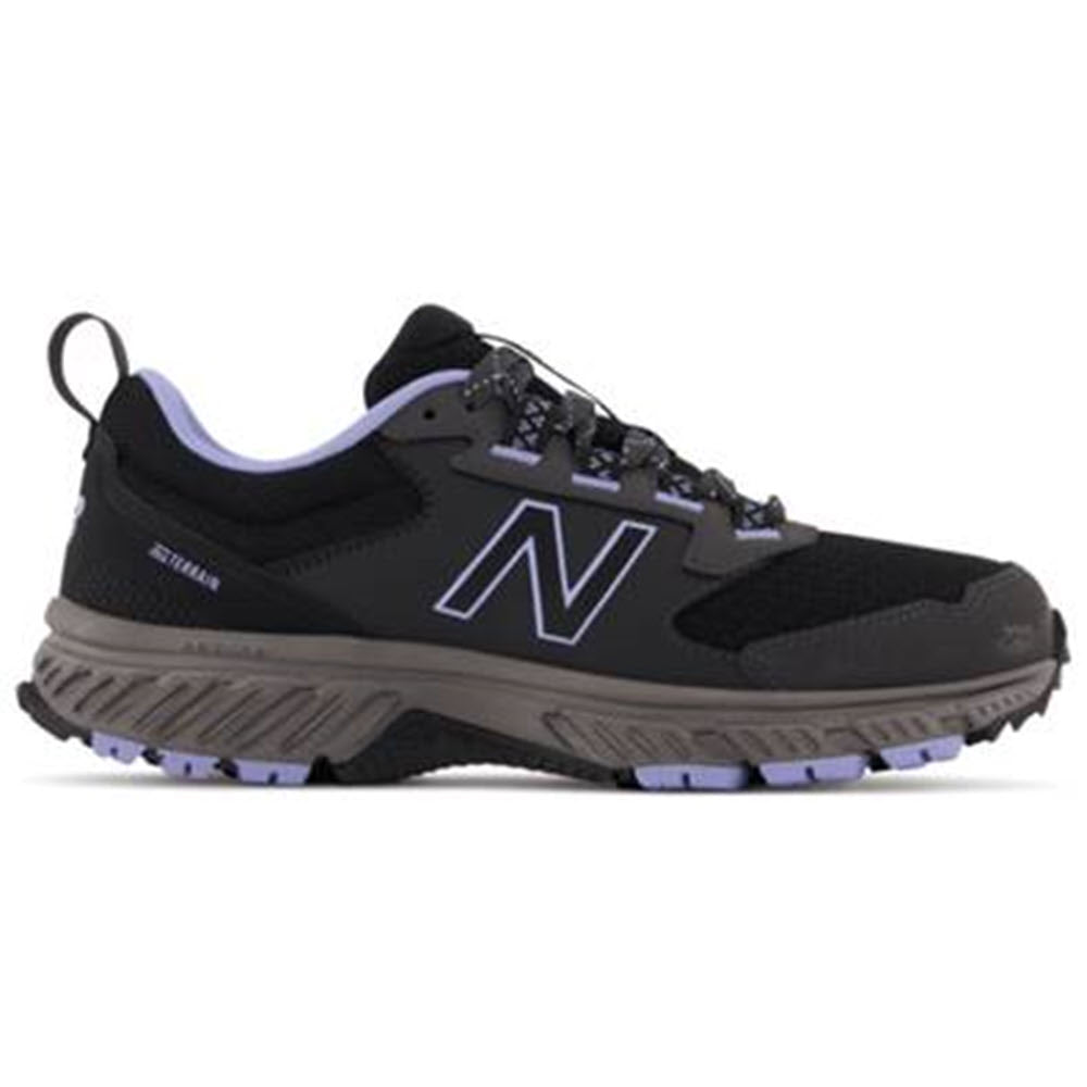 A black New Balance T510V5 trail running shoe with a prominent "n" logo on the side, featuring ABZORB technology.
