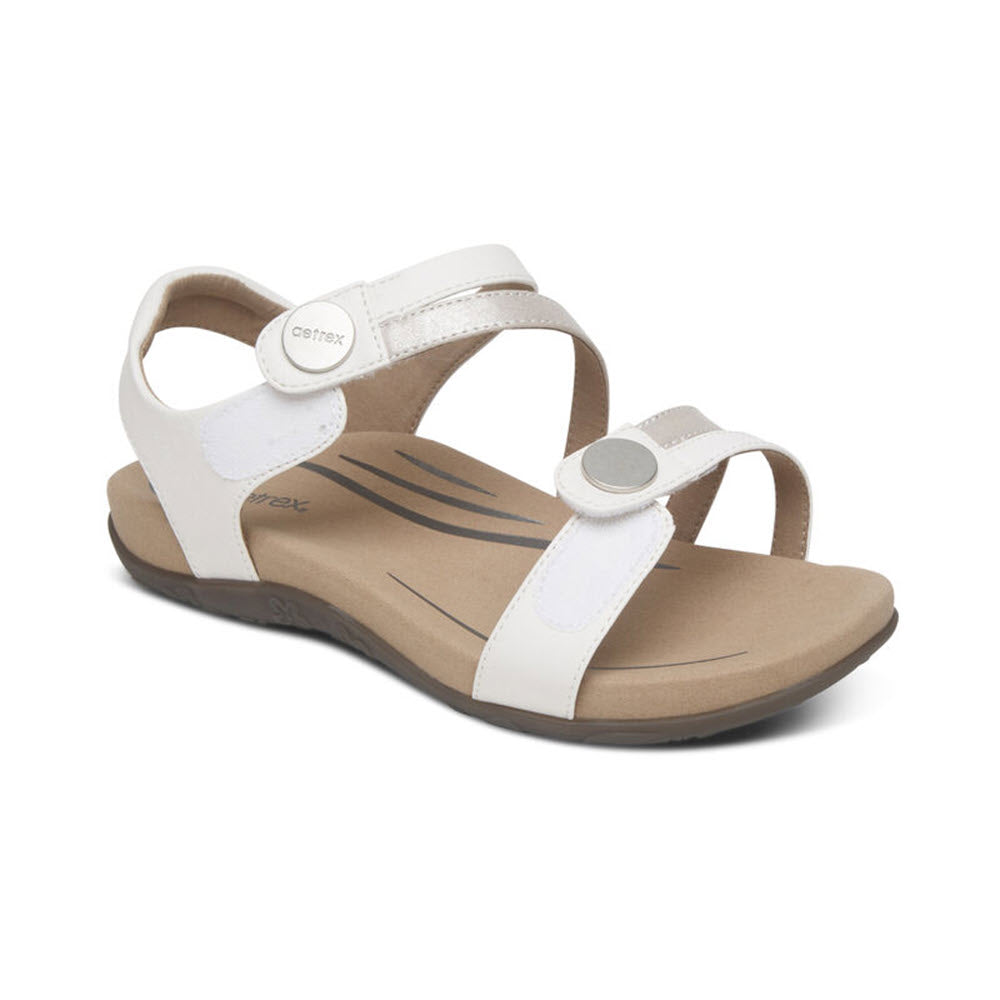 Aetrex Jess White women&#39;s sandal with a tan sole and memory foam footbed on a white background.