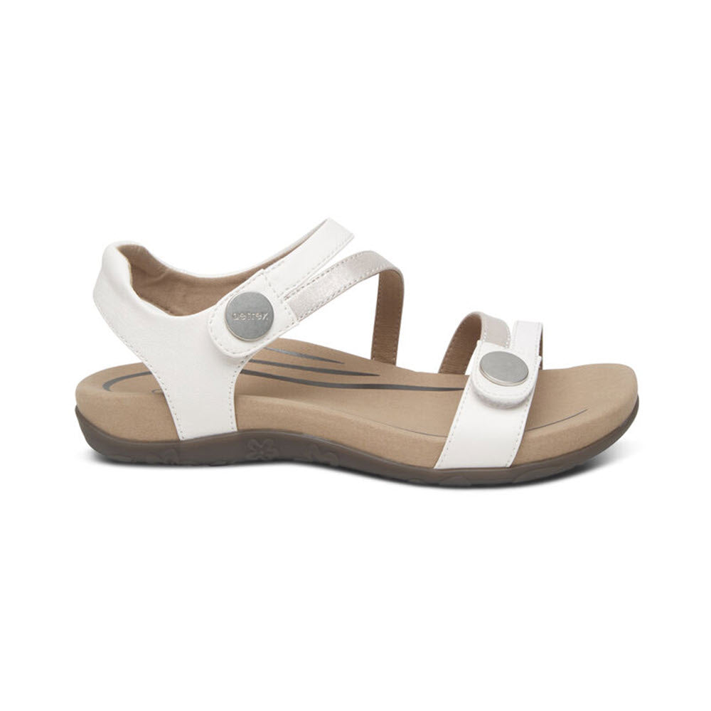 A single white AETREX JESS WHITE - WOMENS sandal with an adjustable strap, arch support, and a cushioned sole against a white background.