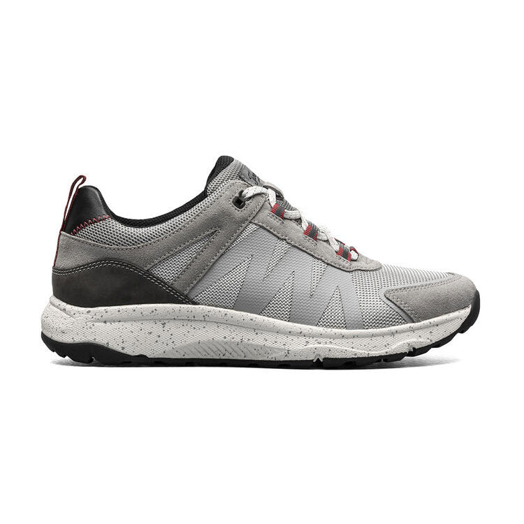 Side view of a Florsheim TREAD LITE MESH LACE GRAY - MENS running shoe with black and red accents, featuring a speckled sole and mesh fabric on the upper part, enhanced by a lightweight design.