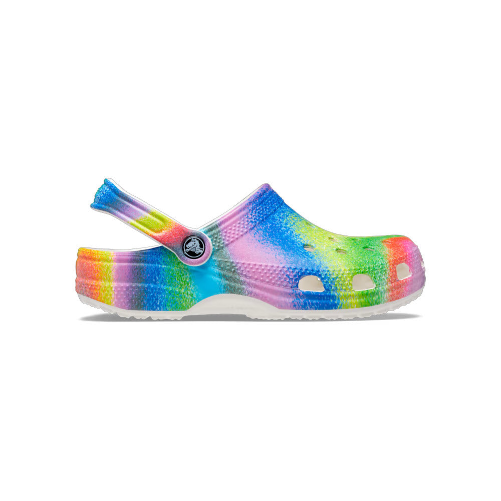 A colorful, tie-dye patterned Crocs Classic Spray Dye Clogs with a pivoting heel strap for iconic Crocs comfort.