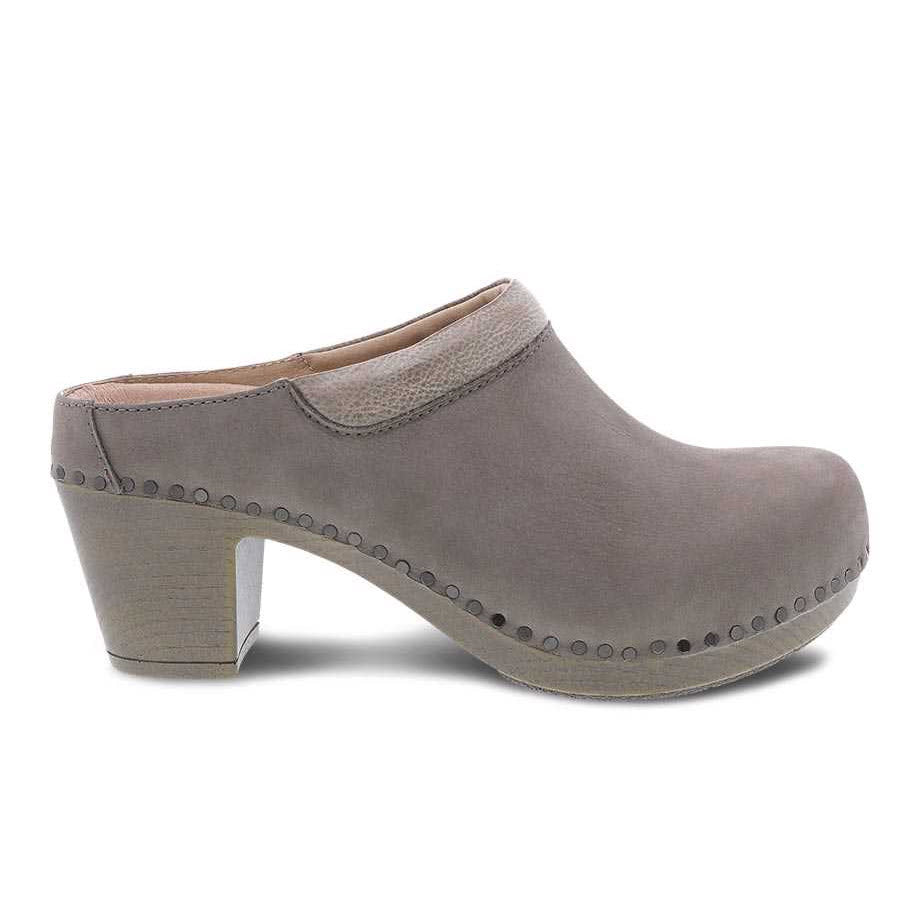 A single gray clog featuring Dansko Nubuck uppers, with a wooden heel and studded detailing.