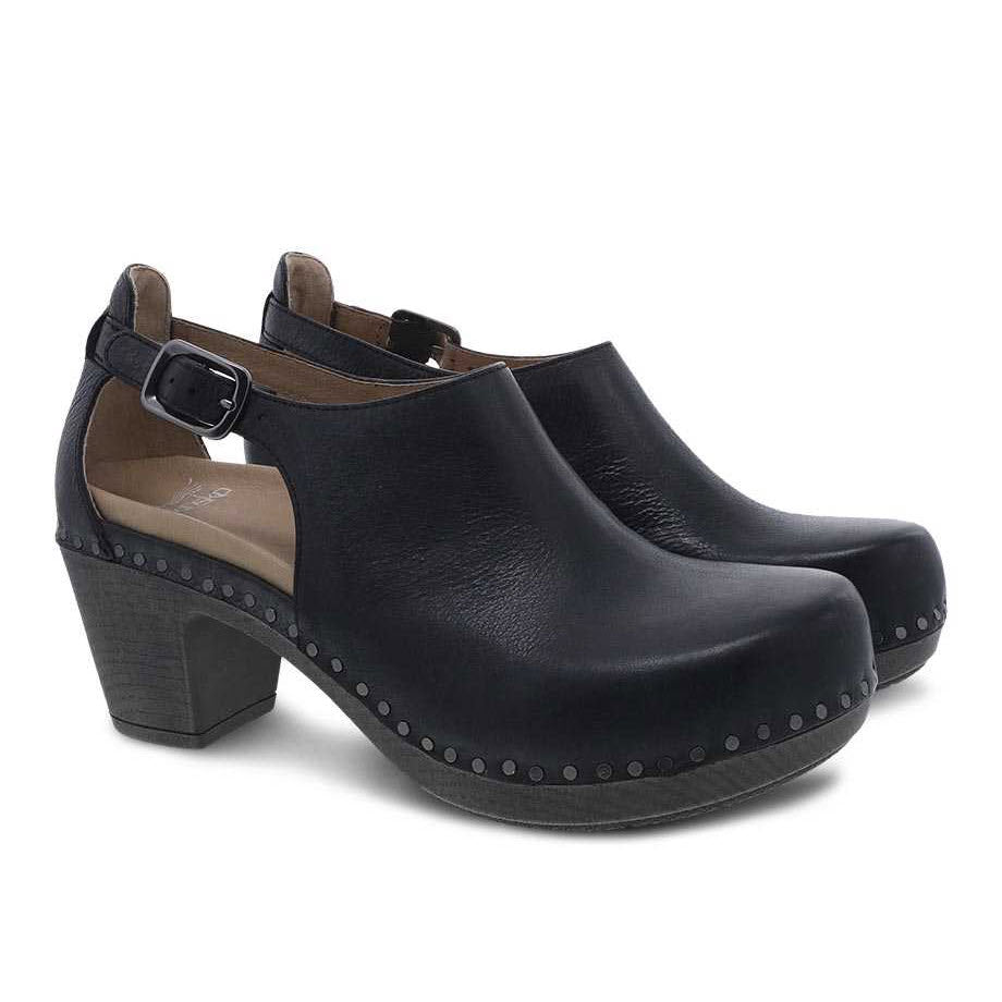 Pair of Dansko Sassy Black - Womens nubuck uppers, heeled clogs with buckle strap and studded detailing.