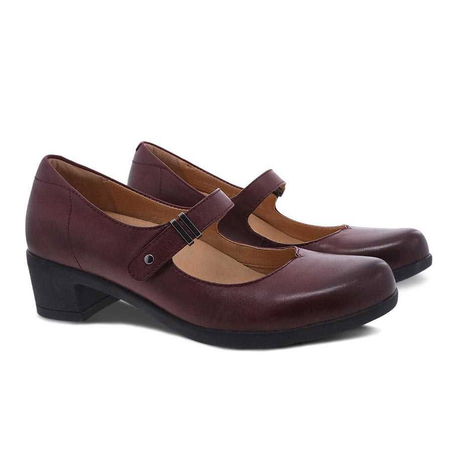 A pair of Dansko Callista Wine Burnished women&#39;s Mary Jane heels with a strap and small black heel, displayed against a white background.