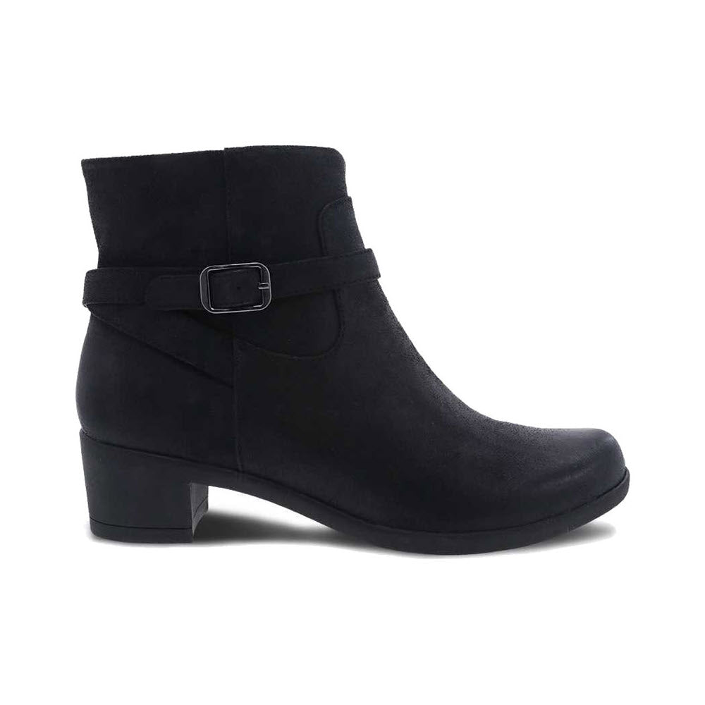 A Dansko Cagney black burnished ankle boot with a low, block heel and a decorative buckle strap, isolated on a white background. Perfectly pairs with skinny jeans.