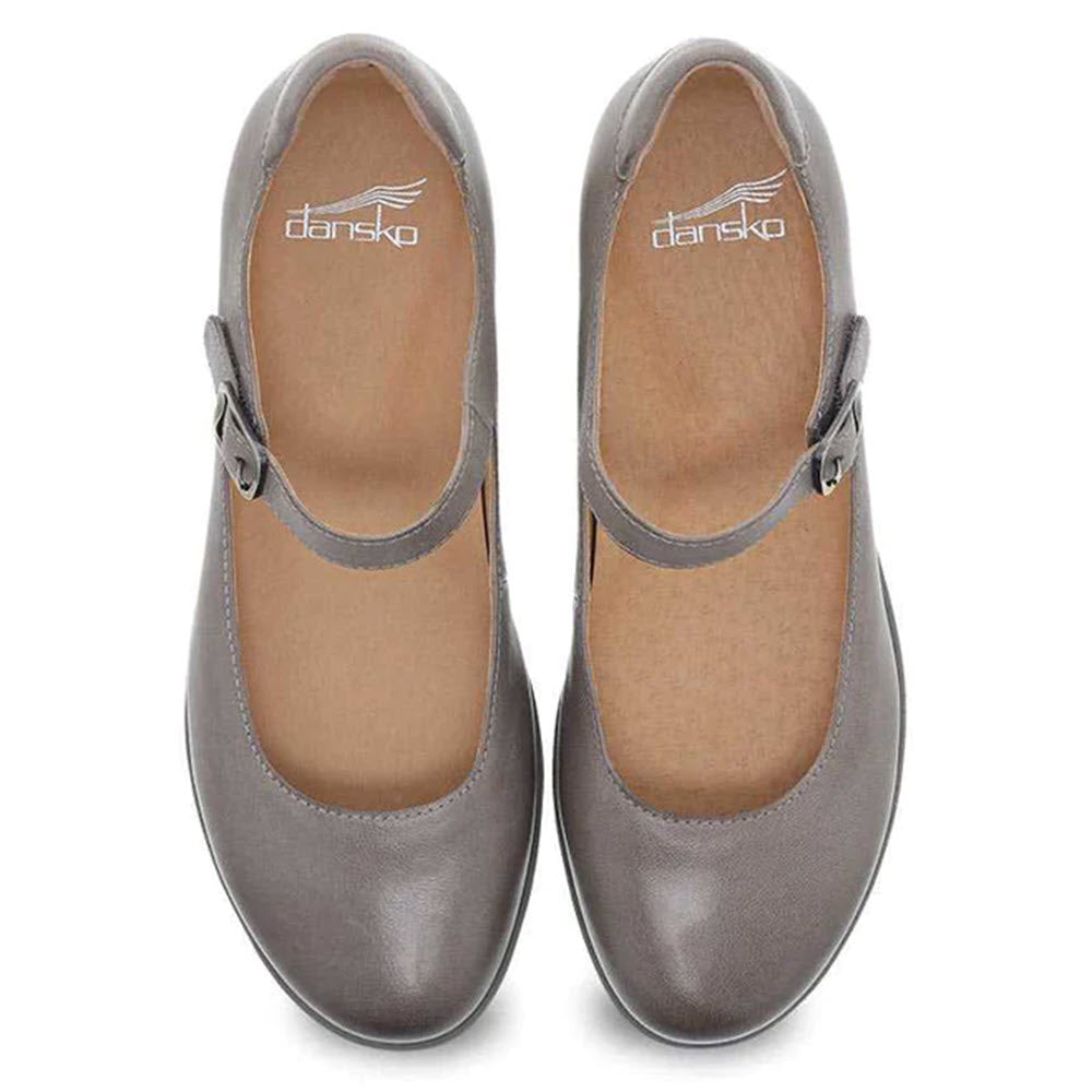 A pair of gray Dansko Marcella Taupe Burnished women&#39;s Mary Jane shoes with a hidden wedge heel, top view.