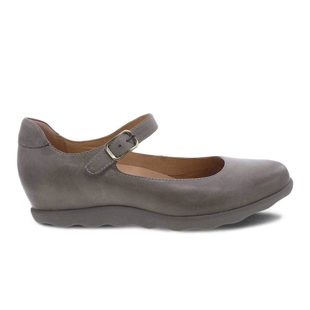 Gray Dansko Marcella Taupe Burnished shoe with a buckle strap on a white background.