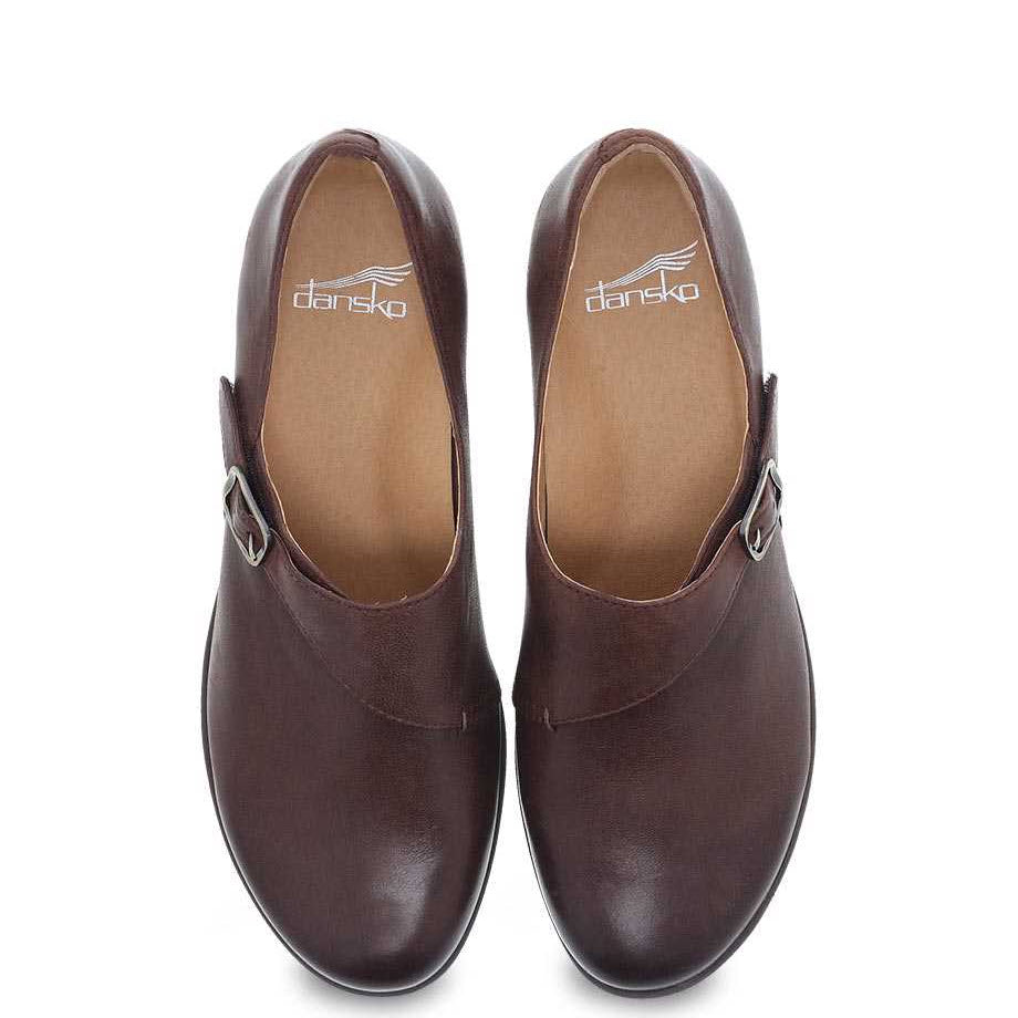 A pair of brown burnished leather Dansko Marisa shoes with leather uppers on a white background.