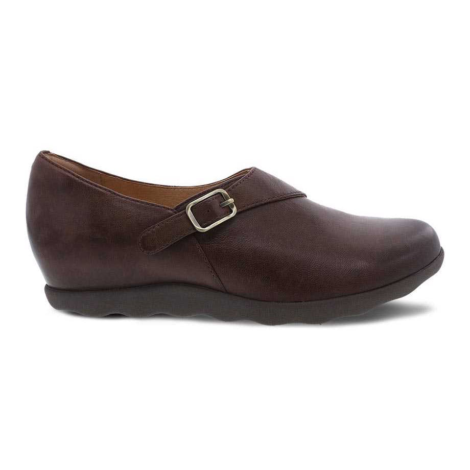 A single Dansko Marisa Brown Burnished women&#39;s casual shoe with a leather upper and buckle detail on a white background.