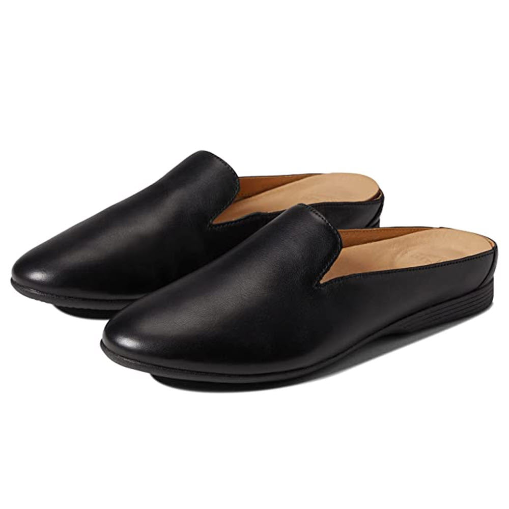 A pair of Dansko Lexie Black mules displayed on a white background.