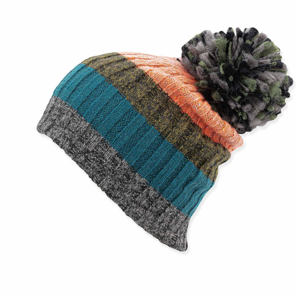 Colorful striped ribbed knit Pistil Halle hat in melon with a large black yarn pompom on a white background.